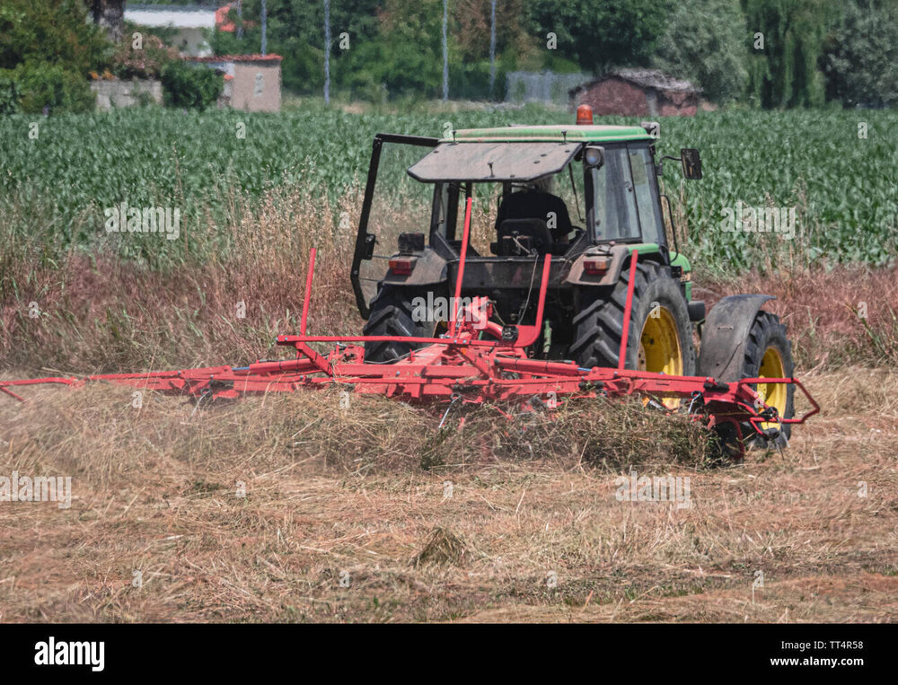 traktor-mit-dreschmaschine-bei-der-arbeit-auf-den-feldern-und-im-sommer-tt4r58.jpg